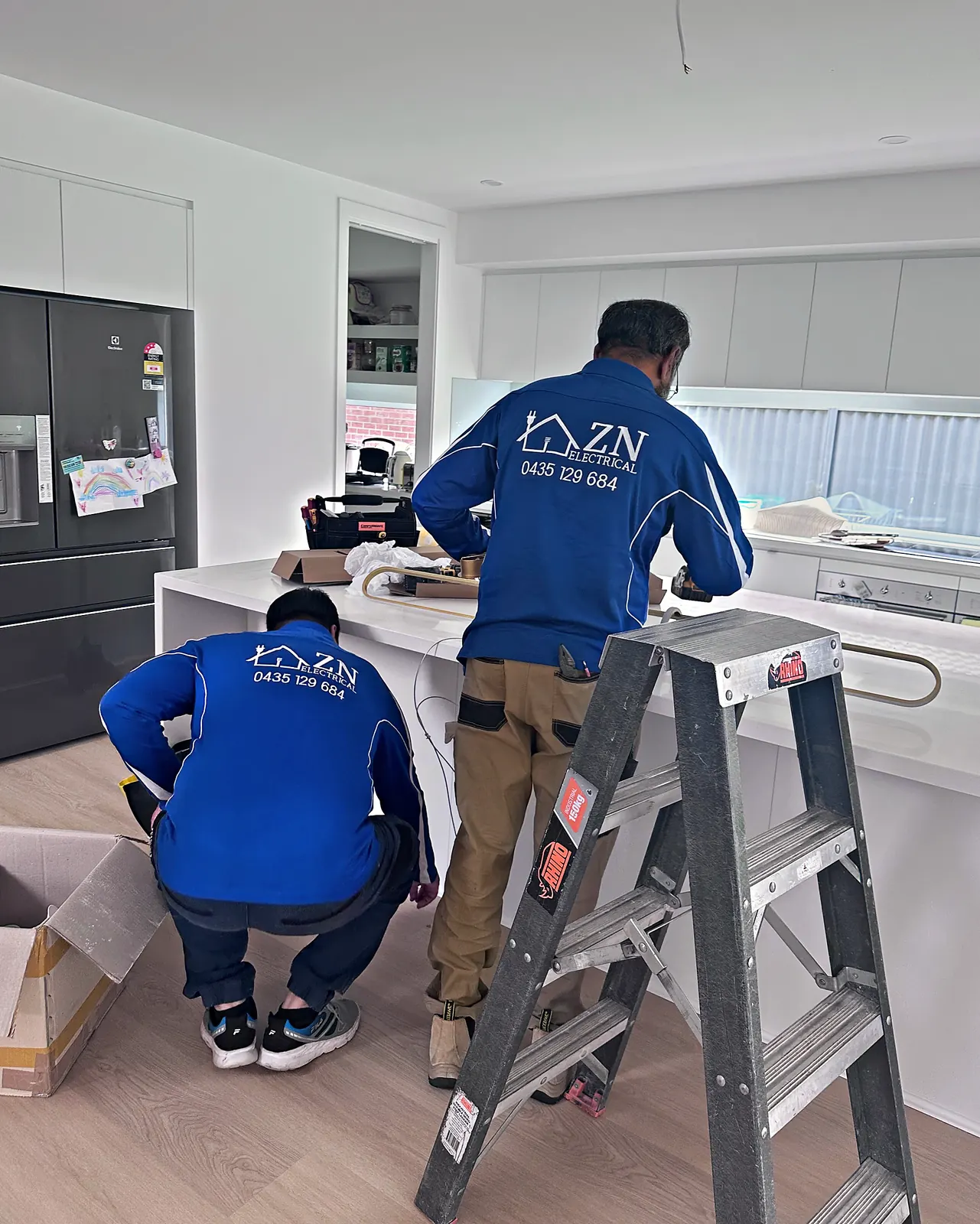 ZN Electrical team installing kitchen lighting